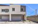 Modern two-story home featuring a gray garage door and neutral paint, complemented by a well-paved driveway at 8629 Ensworth St # 111, Las Vegas, NV 89123