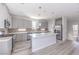 Bright, open kitchen with island, stainless steel appliances, and modern gray cabinets at 8629 Ensworth St # 111, Las Vegas, NV 89123