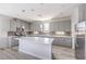 Modern kitchen featuring gray cabinetry, stainless appliances, and a large island at 8629 Ensworth St # 111, Las Vegas, NV 89123