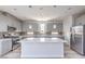 Modern kitchen features a large island, stainless steel appliances, and gray cabinetry at 8629 Ensworth St # 111, Las Vegas, NV 89123