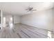 Open-concept living room with light gray wood flooring and a ceiling fan at 8629 Ensworth St # 111, Las Vegas, NV 89123