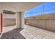 View of the backyard patio area featuring stone pavers and gravel extending to a block wall fence at 8629 Ensworth St # 111, Las Vegas, NV 89123