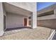 Backyard patio area showcasing stone pavers, gravel ground cover, and a modern red door entrance at 8629 Ensworth St # 111, Las Vegas, NV 89123