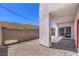 Backyard patio space with a tiled area that leads to a sliding glass door at 8629 Ensworth St # 111, Las Vegas, NV 89123