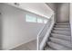 Modern staircase with carpeted steps and a white railing with a metal wire design at 8629 Ensworth St # 111, Las Vegas, NV 89123