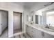 Spa-like bathroom featuring double sinks, a vanity, and a glass shower at 8629 Ensworth St # 112, Las Vegas, NV 89123