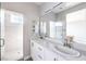 Modern bathroom features dual sinks, large mirror, and glass shower at 8629 Ensworth St # 112, Las Vegas, NV 89123