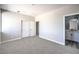 Neutral bedroom with carpeted floors featuring a double door closet and an attached bathroom at 8629 Ensworth St # 112, Las Vegas, NV 89123