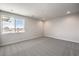 Bedroom with large windows offering city views, neutral walls, and plush carpet at 8629 Ensworth St # 112, Las Vegas, NV 89123