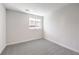 Cozy bedroom featuring neutral carpet and a bright window at 8629 Ensworth St # 112, Las Vegas, NV 89123