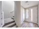 Inviting entryway showcasing a staircase, wood-look flooring, and a white front door with sidelight window at 8629 Ensworth St # 112, Las Vegas, NV 89123