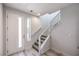 Bright entryway features a modern staircase with metal railings and stylish, light wood flooring at 8629 Ensworth St # 112, Las Vegas, NV 89123