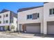 Contemporary two-story home featuring neutral colors and a two-car garage, set against a blue sky at 8629 Ensworth St # 112, Las Vegas, NV 89123