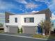 Modern two-story home featuring a clean white facade, gray accents, and well-manicured landscaping at 8629 Ensworth St # 112, Las Vegas, NV 89123
