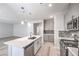 Bright, open-concept kitchen with a center island, stainless appliances, and modern fixtures at 8629 Ensworth St # 112, Las Vegas, NV 89123