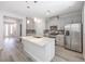 Modern kitchen features a central island, stainless steel appliances, and gray cabinetry at 8629 Ensworth St # 112, Las Vegas, NV 89123