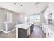 Bright kitchen featuring a kitchen island, white cabinets, and scenic window views at 8629 Ensworth St # 112, Las Vegas, NV 89123