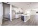 Open kitchen design with an island, modern cabinets, and wood-look flooring, perfect for entertaining at 8629 Ensworth St # 112, Las Vegas, NV 89123