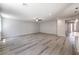 Open-concept living area with light wood flooring and neutral walls, perfect for modern living at 8629 Ensworth St # 112, Las Vegas, NV 89123