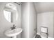 Stylish powder room with a modern pedestal sink and fixtures at 8629 Ensworth St # 112, Las Vegas, NV 89123
