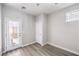 Bright room with wood-look floors, a door to the outside, and a closet at 8629 Ensworth St # 112, Las Vegas, NV 89123