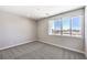 Comfortable bedroom with carpet flooring, neutral walls, and a window overlooking the outside at 8629 Ensworth St # 113, Las Vegas, NV 89123
