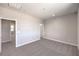 Bright bedroom with carpet flooring and two openings; one to the hallway, the other to a bathroom at 8629 Ensworth St # 113, Las Vegas, NV 89123