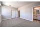 Spacious bedroom with neutral walls, carpet flooring, closet, and a view of the connected bathroom at 8629 Ensworth St # 113, Las Vegas, NV 89123