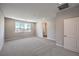 Bright bedroom featuring plush carpeting, a large window, and neutral wall paint at 8629 Ensworth St # 113, Las Vegas, NV 89123