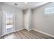 An entryway with light wood-look floors with a door to the back yard, and a white interior door at 8629 Ensworth St # 113, Las Vegas, NV 89123