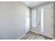 Bright entryway featuring a white door with glass inserts and light wood-look flooring, leading into the home at 8629 Ensworth St # 113, Las Vegas, NV 89123