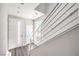 Bright hallway with modern railing leading upstairs and a sleek door with a glass insert at 8629 Ensworth St # 113, Las Vegas, NV 89123