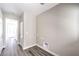 Hallway showing the hookups for a washer/dryer and modern grey flooring at 8629 Ensworth St # 113, Las Vegas, NV 89123