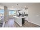Bright kitchen features an island with stainless steel appliances and white cabinets at 8629 Ensworth St # 113, Las Vegas, NV 89123
