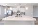 Beautiful kitchen island featuring white quartz countertop, stainless sink and modern lighting at 8629 Ensworth St # 113, Las Vegas, NV 89123