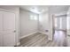 Spacious laundry room with light wood-look floors and white walls, featuring a door and window at 8629 Ensworth St # 113, Las Vegas, NV 89123