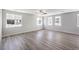 Open living room with light wood-look floors and multiple windows, providing ample natural light at 8629 Ensworth St # 113, Las Vegas, NV 89123