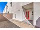 Private backyard area with low-maintenance landscaping and a bright red entry door at 8629 Ensworth St # 114, Las Vegas, NV 89123