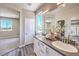 Bathroom featuring a double vanity, large mirror, and wood-look floors at 8629 Ensworth St # 114, Las Vegas, NV 89123