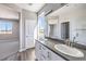 Bright bathroom featuring a double sink vanity with contemporary finishes and a view into an adjacent room at 8629 Ensworth St # 114, Las Vegas, NV 89123