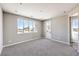 Light filled bedroom with plush carpet, ensuite bath, and a private outdoor balcony at 8629 Ensworth St # 114, Las Vegas, NV 89123