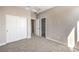 Carpeted bedroom featuring a closet and two doors, one leading to an ensuite bathroom at 8629 Ensworth St # 114, Las Vegas, NV 89123