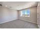 Bedroom with natural light from a large window with neutral colored walls and carpet at 8629 Ensworth St # 114, Las Vegas, NV 89123