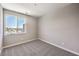 Cozy bedroom with neutral carpet, paint, and a large window with outside views at 8629 Ensworth St # 114, Las Vegas, NV 89123
