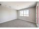 Neutral bedroom with plush carpeting and a large window showing city views at 8629 Ensworth St # 114, Las Vegas, NV 89123