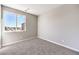 Bright, carpeted bedroom with a large window offering natural light and city views at 8629 Ensworth St # 114, Las Vegas, NV 89123