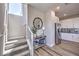 Welcoming entryway with a staircase, stylish console table, and views of the modern kitchen, creating a warm and inviting atmosphere at 8629 Ensworth St # 114, Las Vegas, NV 89123