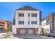 Modern two-story townhome showcasing a neutral color scheme, multiple windows, and an attached two-car garage at 8629 Ensworth St # 114, Las Vegas, NV 89123