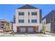 Modern two-story home featuring gray and white facade, and an attached two-car garage with grey doors at 8629 Ensworth St # 114, Las Vegas, NV 89123