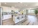Modern kitchen features white cabinets, gray countertops, and an island with seating, creating an inviting and functional space at 8629 Ensworth St # 114, Las Vegas, NV 89123